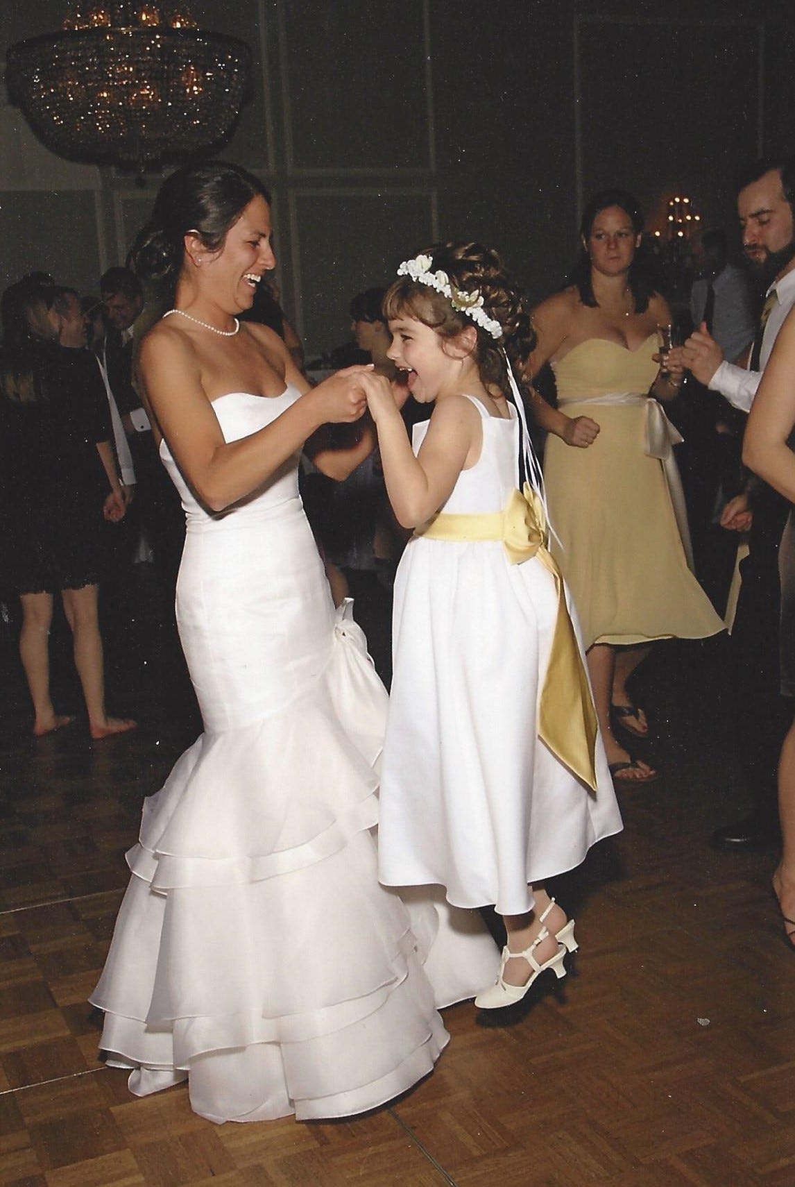 Bride dances with the flower girl, who is having the time of her life