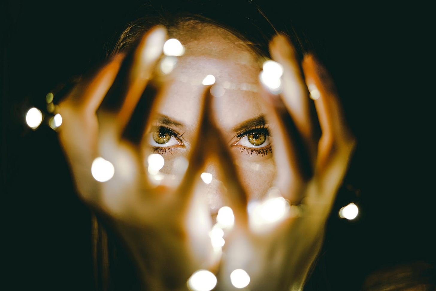 Woman with beautiful eyes and fairy lights