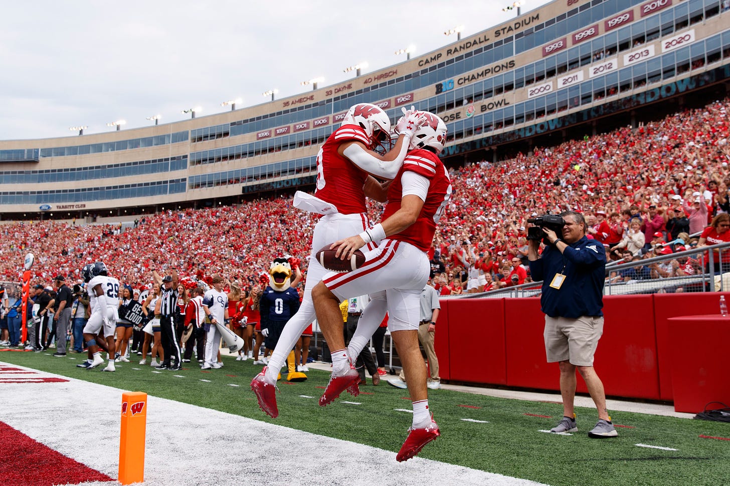 Wisconsin football players Tanner Mordecai and Chimere Dike celebrate a touchdown.