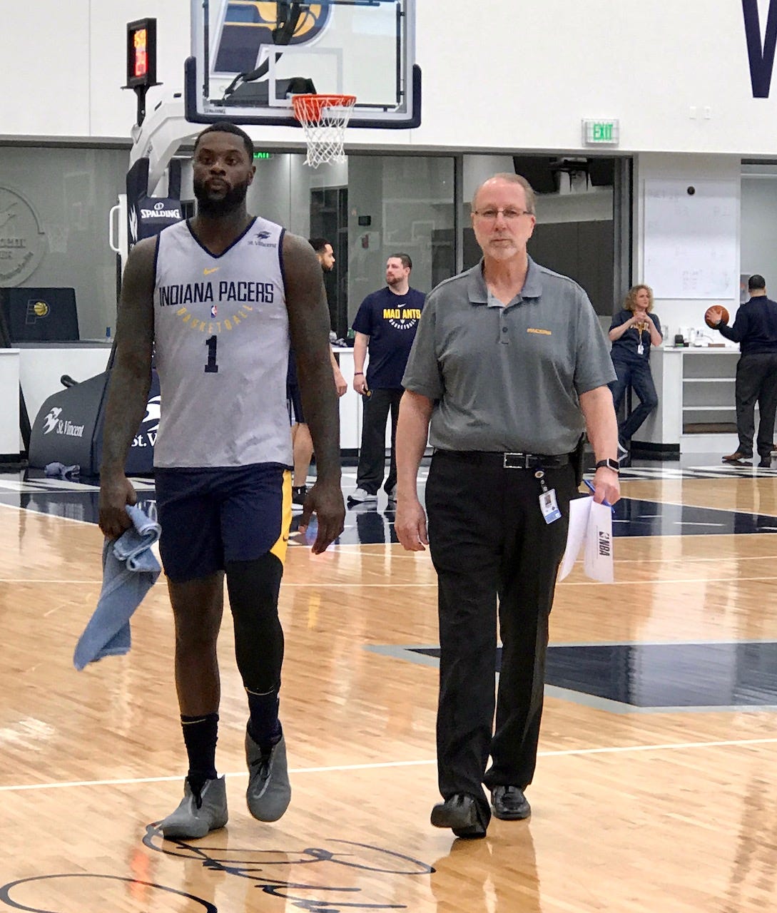 David Benner walks Lance Stephenson over to talk with local media after practice.