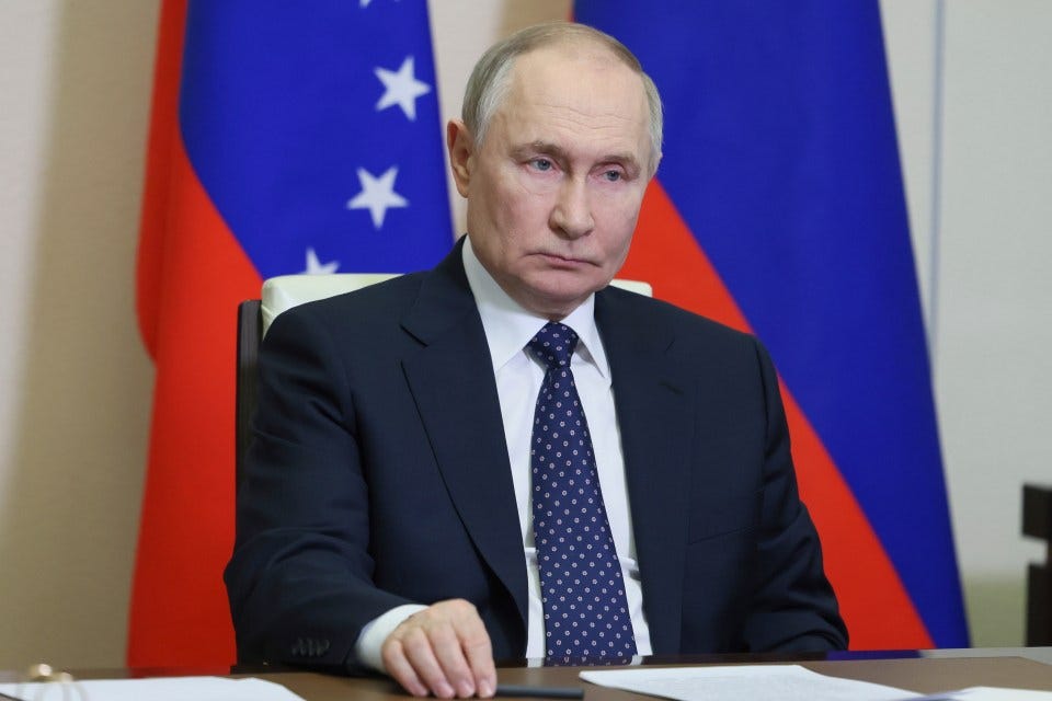 Vladimir Putin listening during a videoconference.