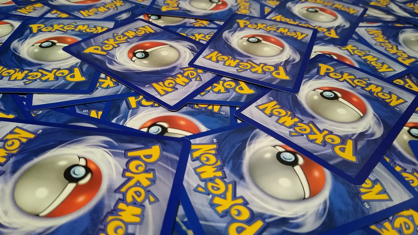 Dozens of Pokémon trading cards showing the Pokémon logo