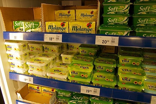 A store shelf with many kinds of margarine on it. Kjetil Ree, CC BY-SA 3.0 <https://creativecommons.org/licenses/by-sa/3.0>, via Wikimedia 