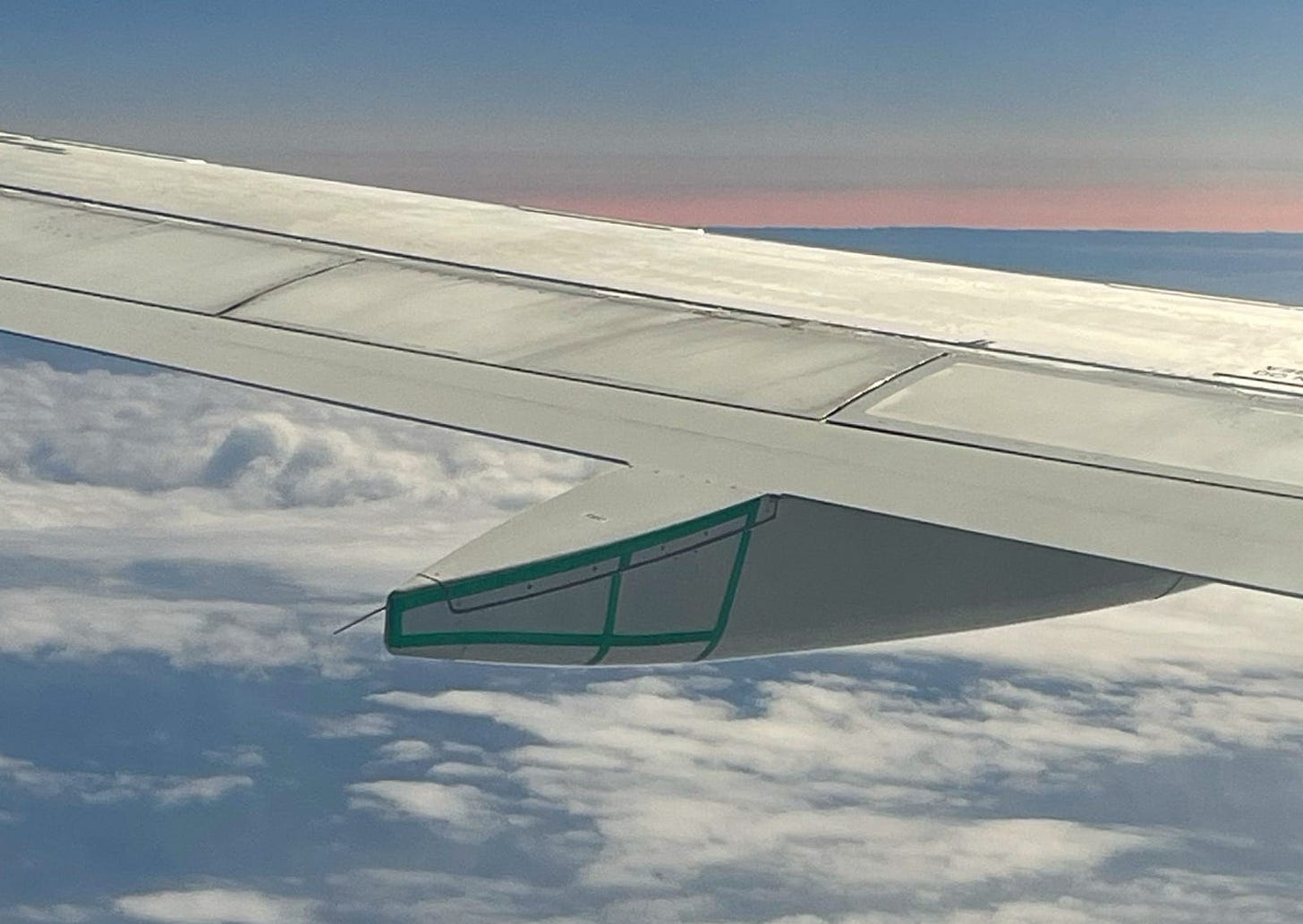 Above the wing of the airplane, you can see the horizon which looked like a sunset for about four or five minutes. It is also slightly darker, especially on the horizon, which is the area where the full eclipse occurred.