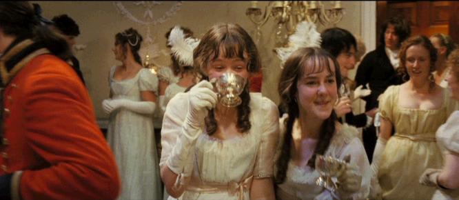 Lydia Bennet and Kitty Bennet are drinking and laughing at the Netherfield Ball. 