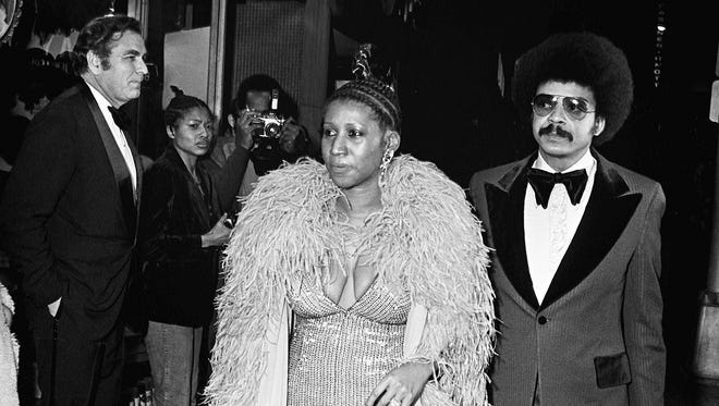 Aretha Franklin, center, draws a crowd as she arrives at the Tennessee Theater for the 15th Grammy Awards show in Nashville March 3. 1973. The show, which will spotlight 11 winners, was televised on CBS.