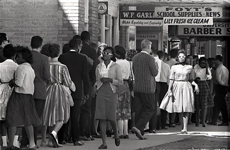 Group of people with a black woman in sunglasses in the middle