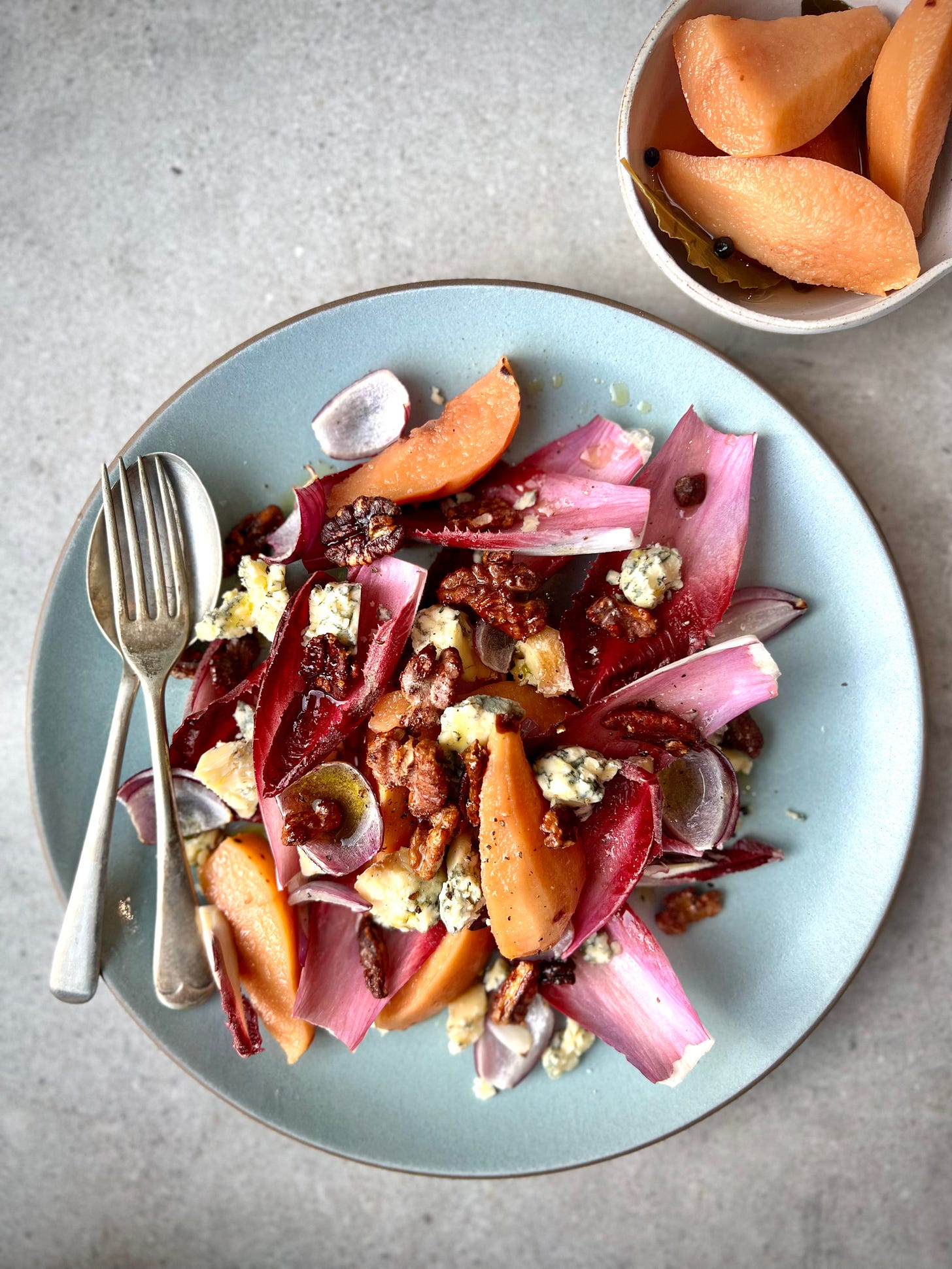 A plate of Chicory, pickled quince and blue cheese salad with maple nuts