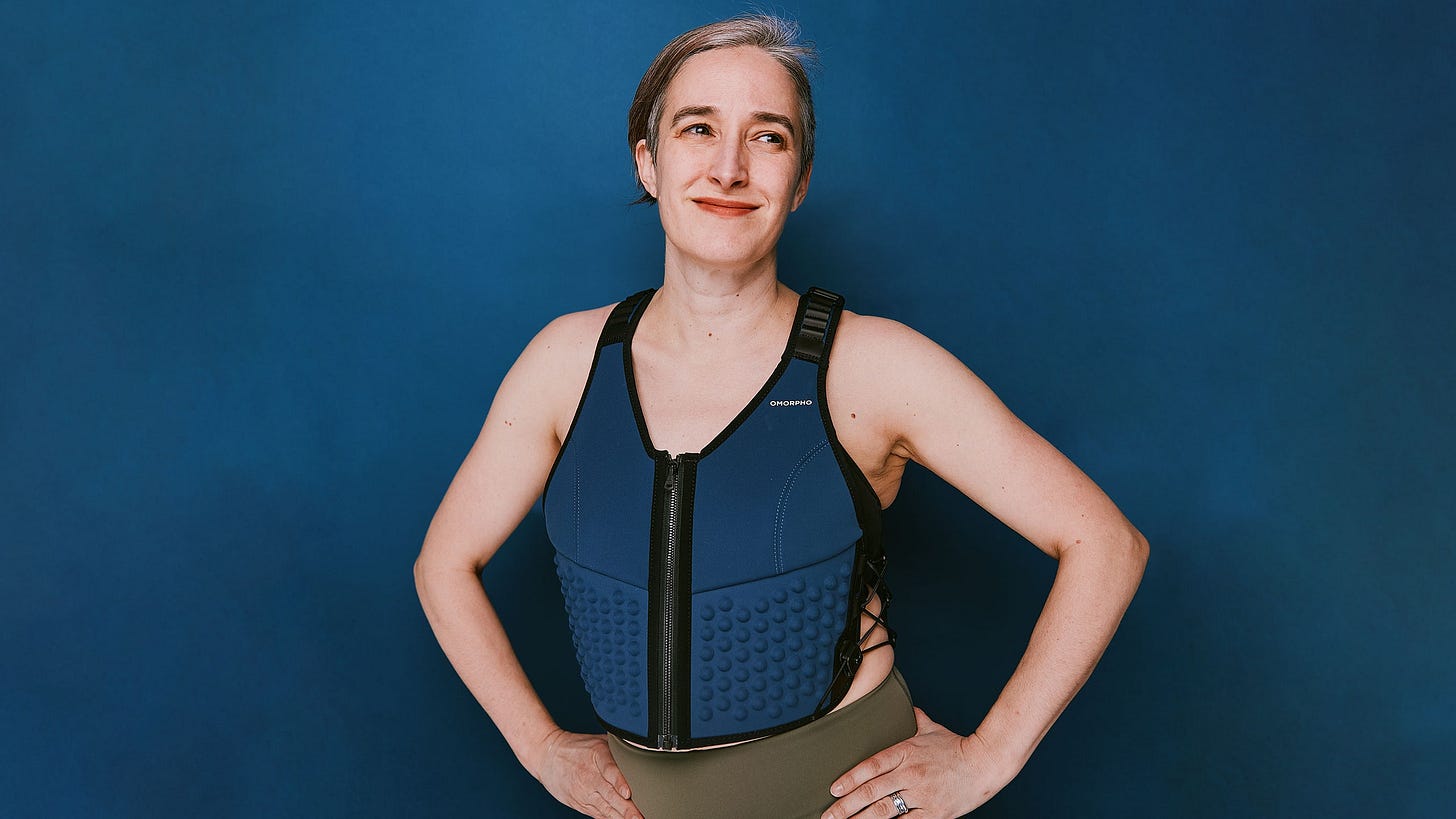 Figure wearing navy blue weighted vest against navy blue background Figure wearing navy blue weighted vest against navy blue background