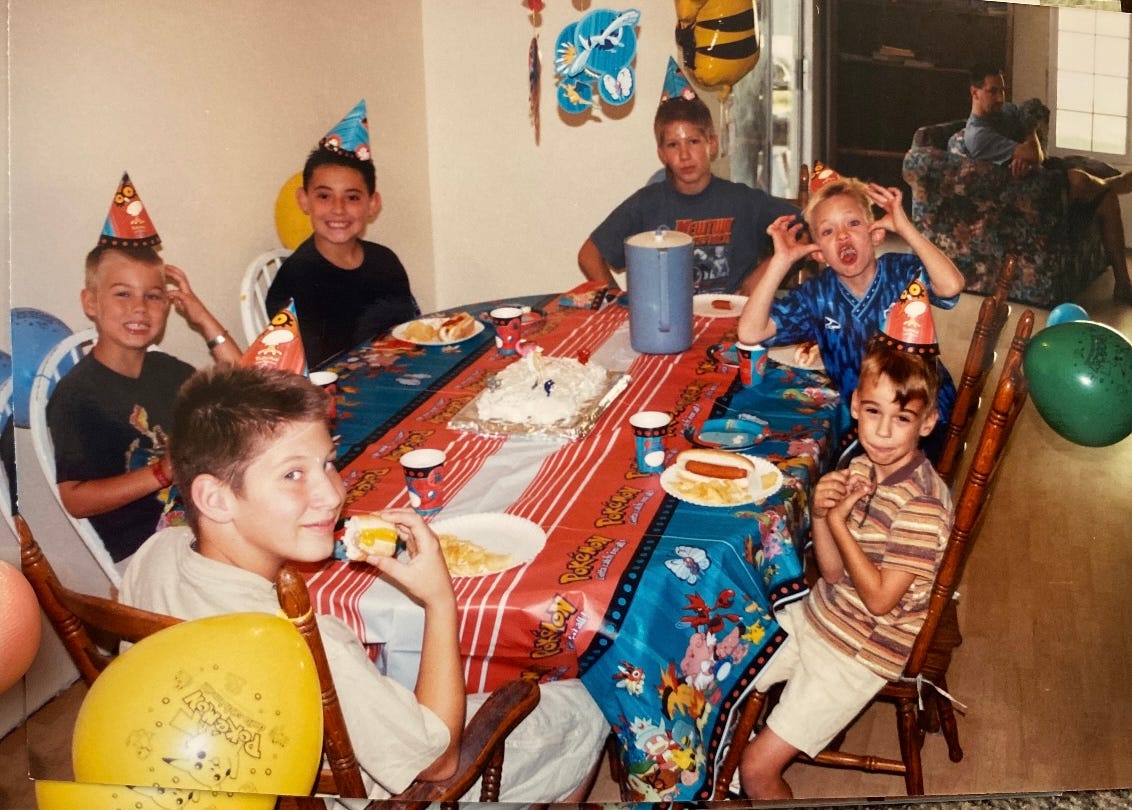 A photograph of Jacob and his friends at a Pokémon-themed party