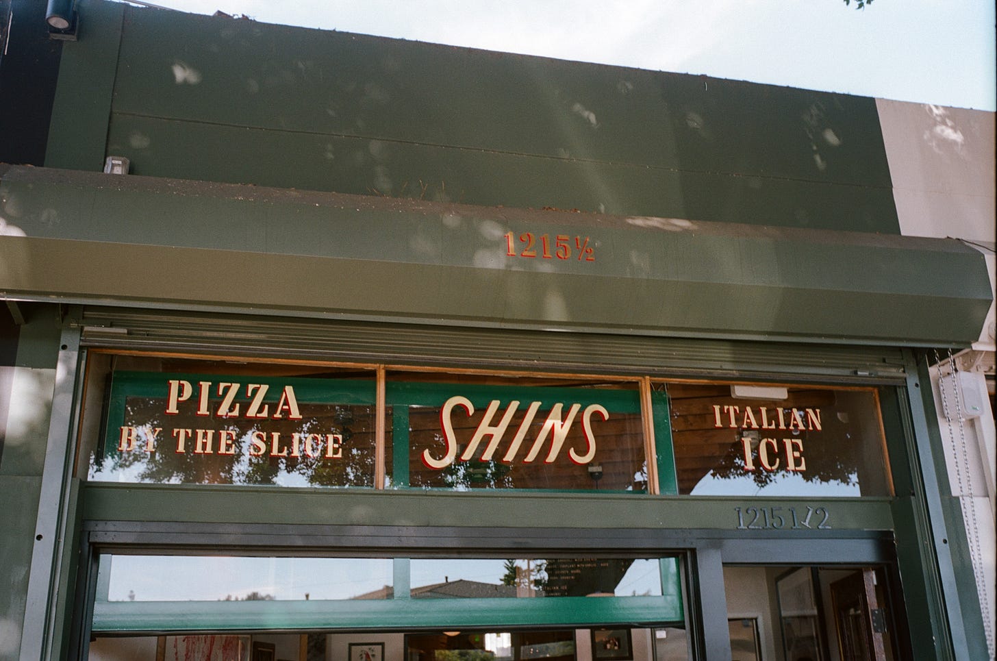 Handpainted signage on Shins Pizza's storefront