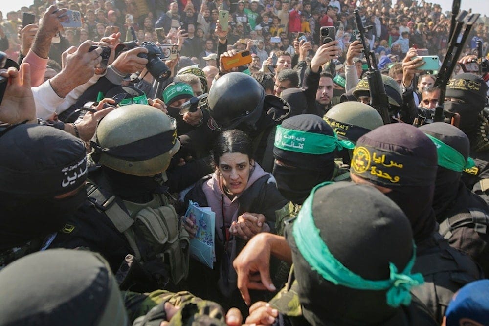 Israeli captive Arbel Yehoud, 29, who has been held in Gaza since October 7, 2023, is escorted by Hamas and Palestinian Islamic Jihad fighters as she is handed over to the Red Cross in Khan Younis, southern Gaza Strip, Thursday, Jan. 30, 2025 (AP)