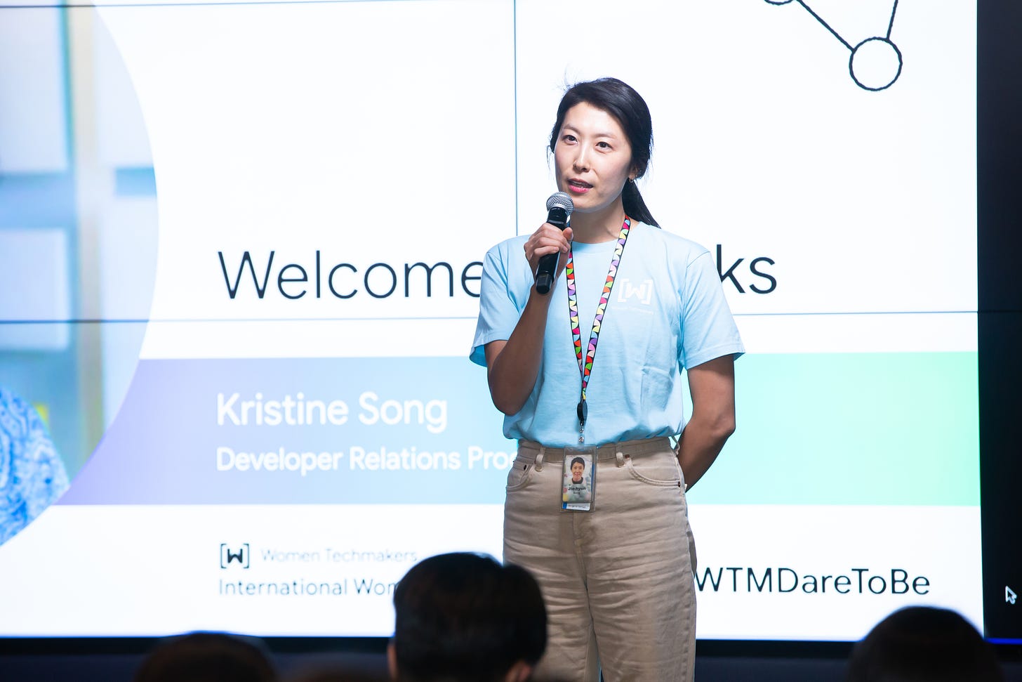 Kristine Song speaking on stage at a conference