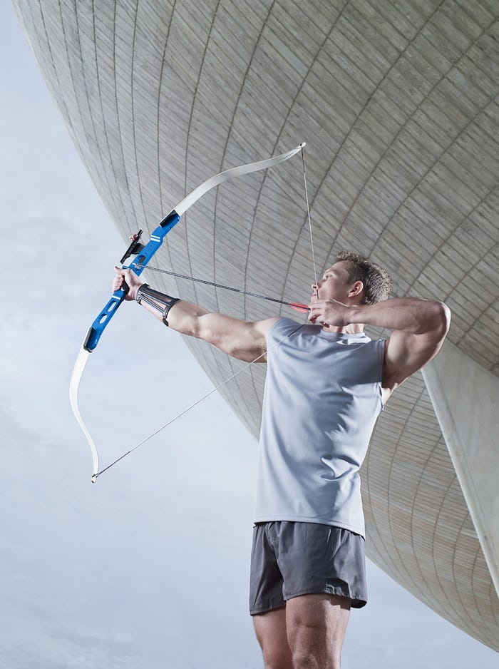A man shooting an arrow towards the sky. A man shooting an arrow towards the sky.