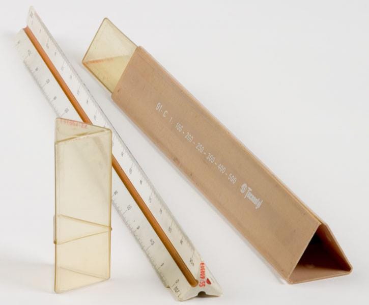 A metal ruler accompanied by its plastic case.