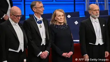 Some of the 2022 Nobel Prize winners standing up at a banquet in Stockholm