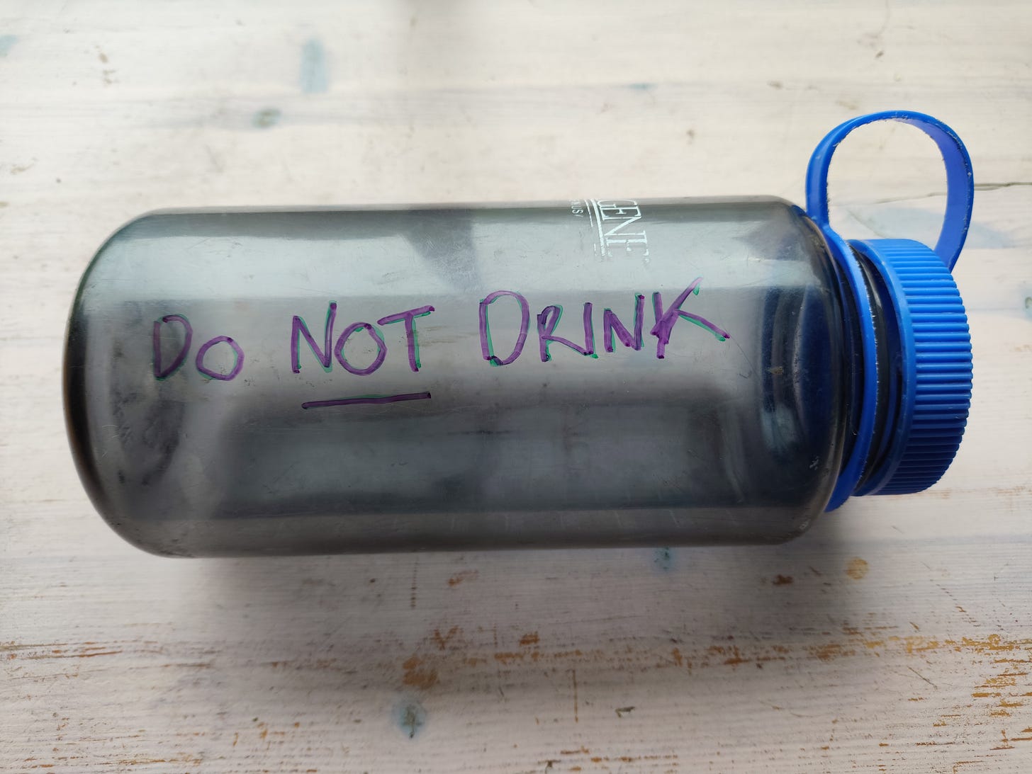 a large water bottle with, "do not drink" written on the side