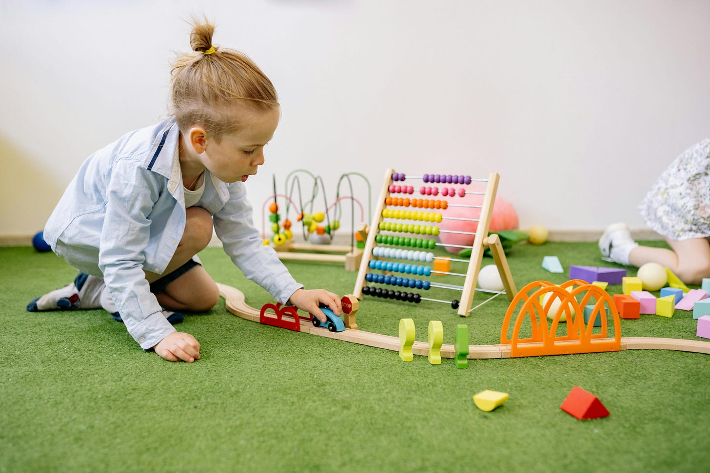 Boy Playing With Wooden Toy Car · Free Stock Photo