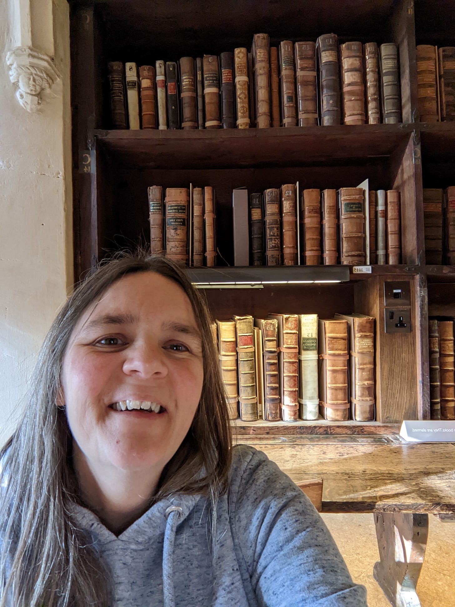 Me sitting amongst the old books at the Bodleian library