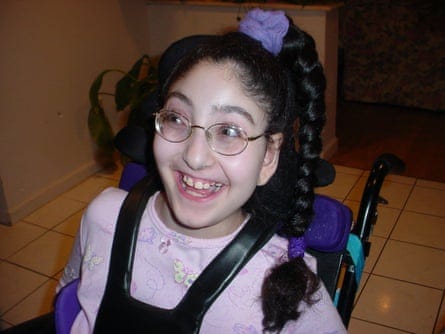 a girl wearing glasses smiles 