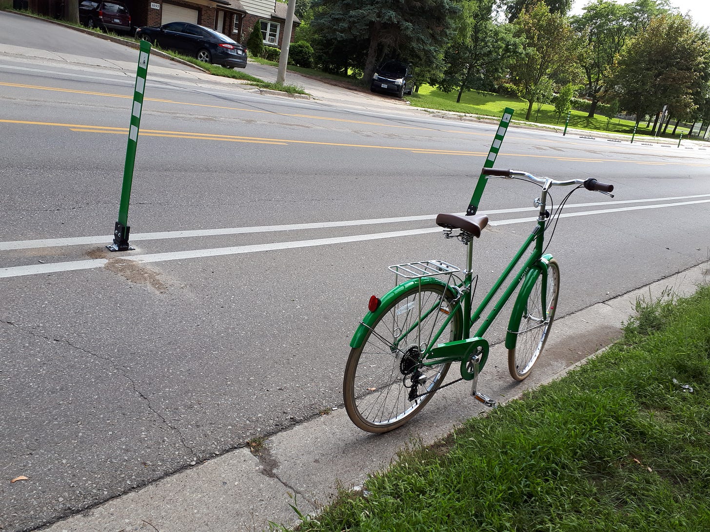Green bike sitting in a bike lane on Queen's Blvd in Kitchener