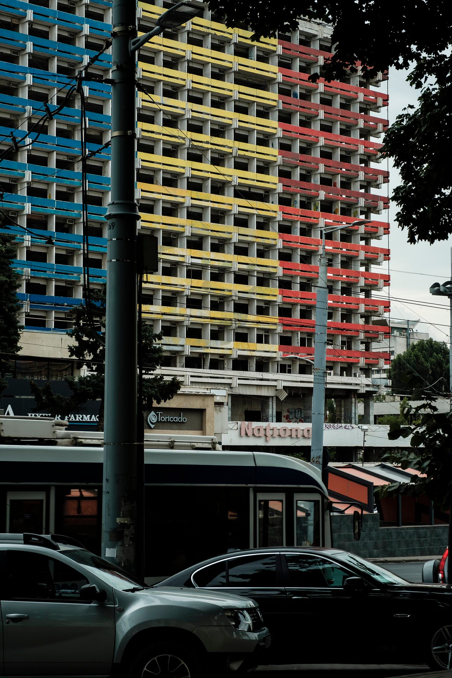 streets of Chisinau, Moldova: concrete façade painted in blue, yellow and red