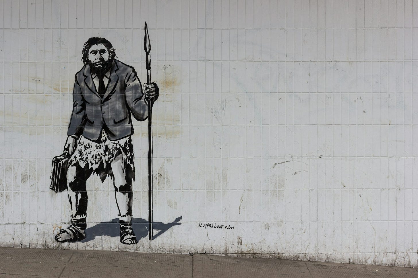 A Banksy-style portrait of a Neandertal wearing a blazer A Banksy-style portrait of a Neandertal wearing a blazer