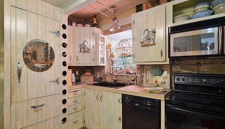 In a million years I would not have guessed black appliances. Or rustic retro. This kitchen features both. 