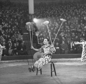 Old black and white image of circus juggler spinning plates