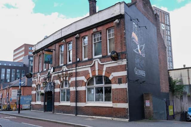 The outside of The Grapes pub in Sheffield with a Guinness painting on the right-hand side The outside of The Grapes pub in Sheffield with a Guinness painting on the right-hand side