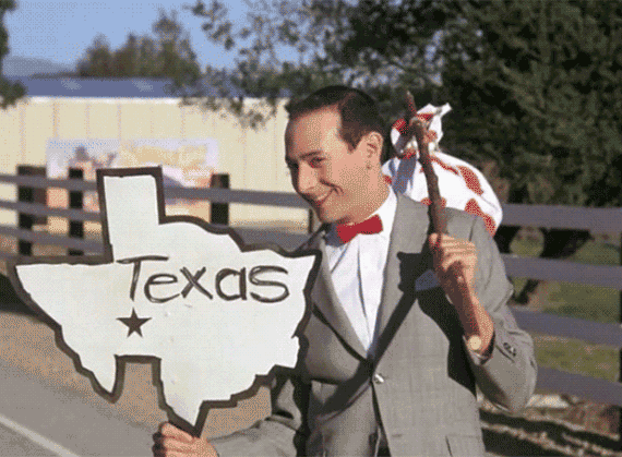 Pee Wee Herman holds a sign that says Texas Pee Wee Herman holds a sign that says Texas