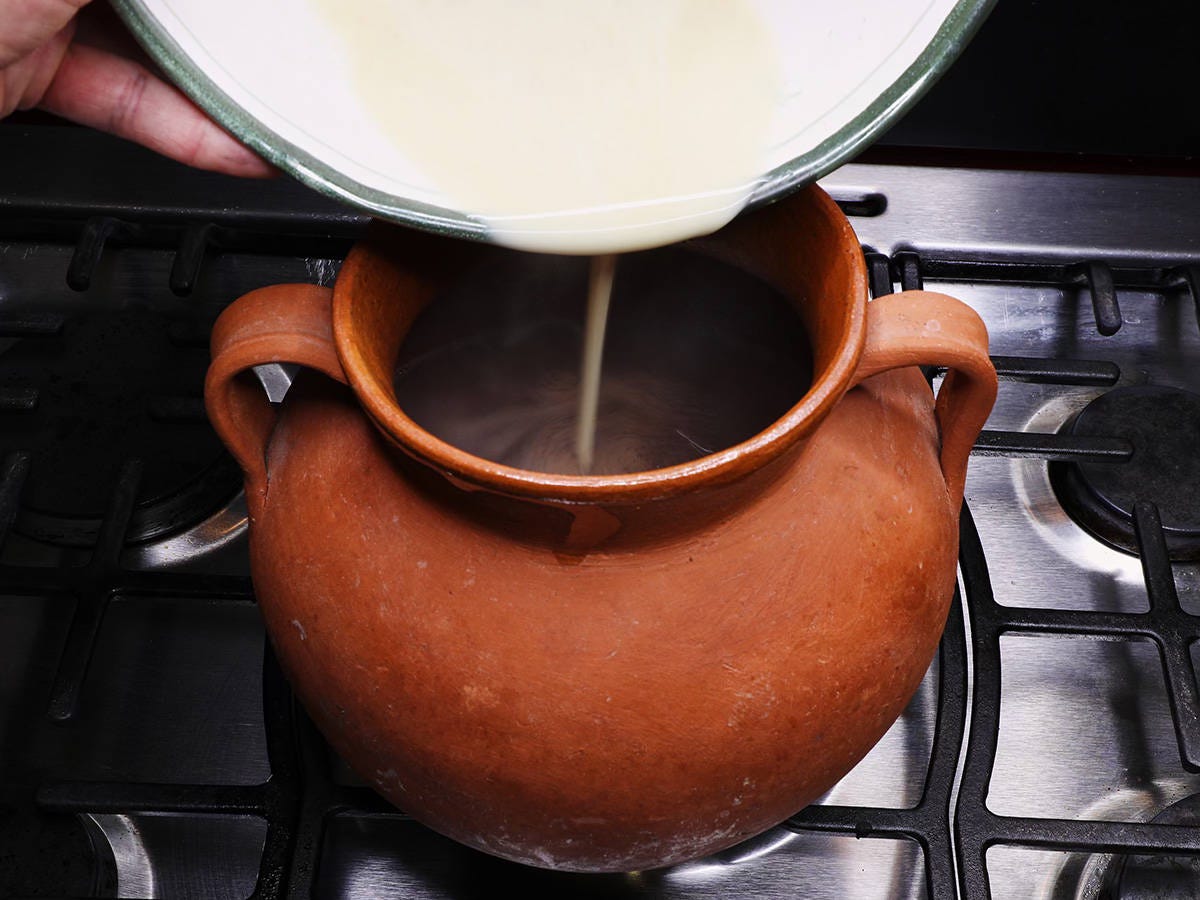 adding masa mix to pot