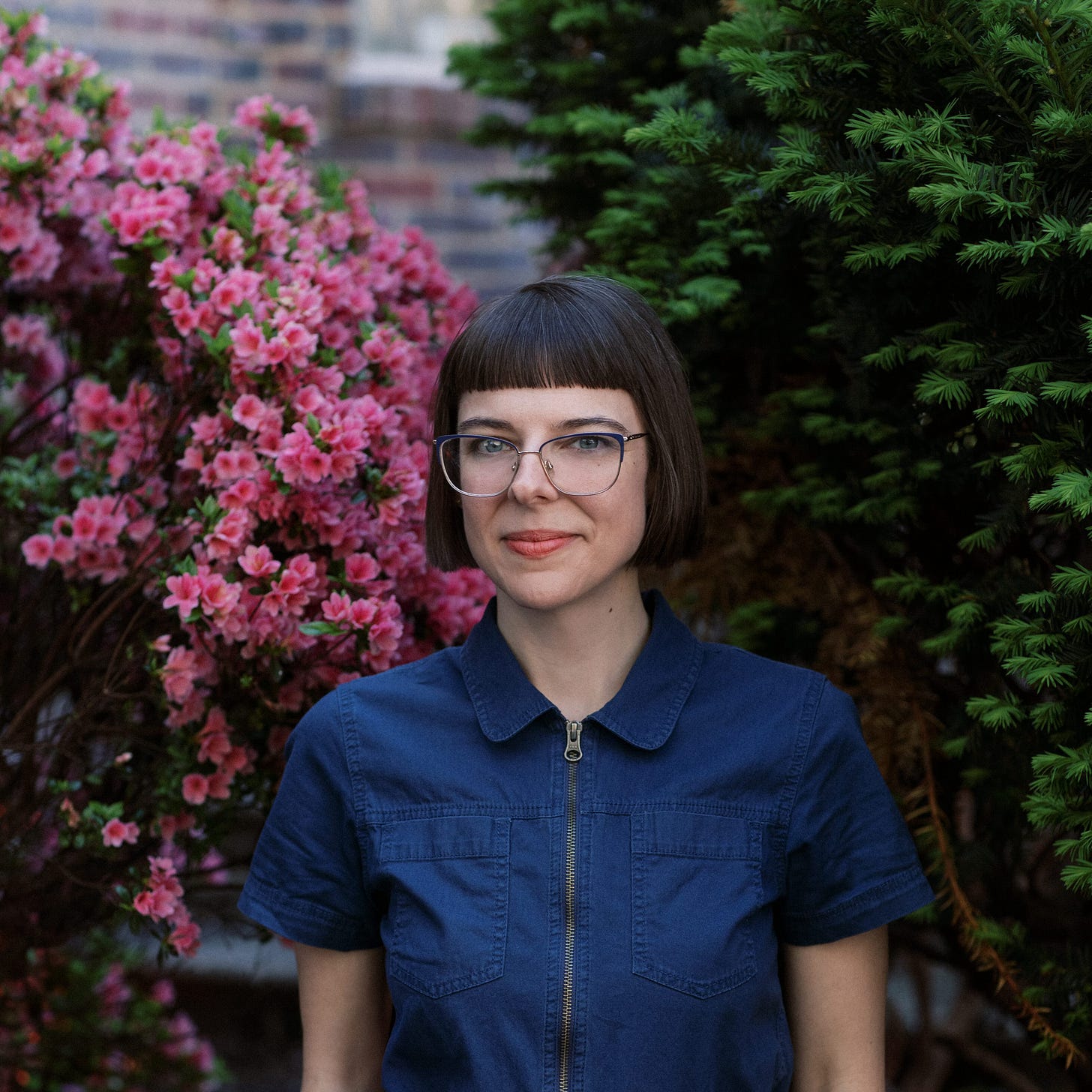 author photo of Shayne Terry with pink flowers in the background