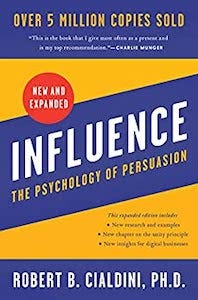 cover of Influence: The Psychology of Persuasion by Robert B. Cialdini, showing the title and author name text against an indigo stripe on a gold background