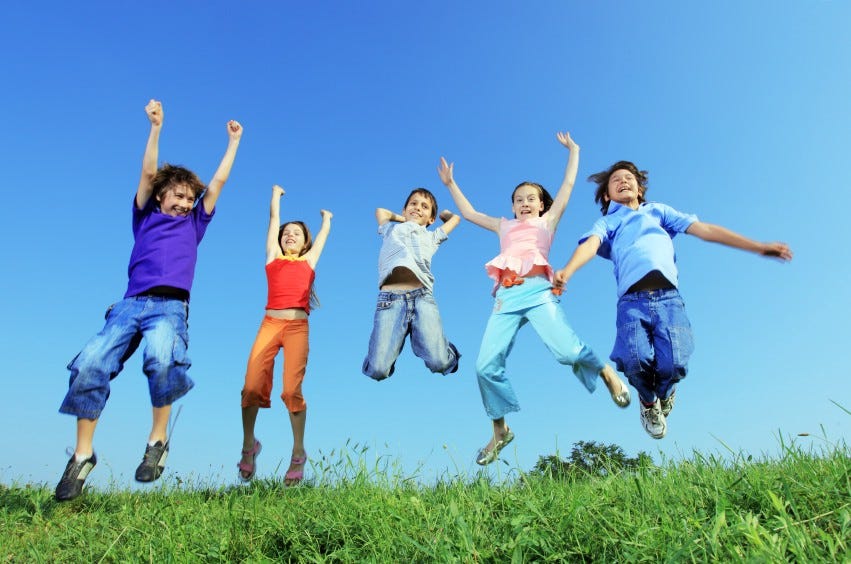 Five kids jumping for joy