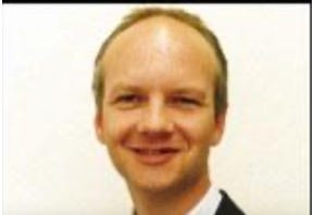 A person smiling for the camera

Description automatically generated