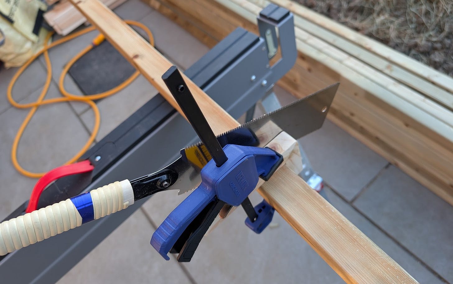 Sawing jig in use. The saw is leaned into the jig to help make a square cut. 