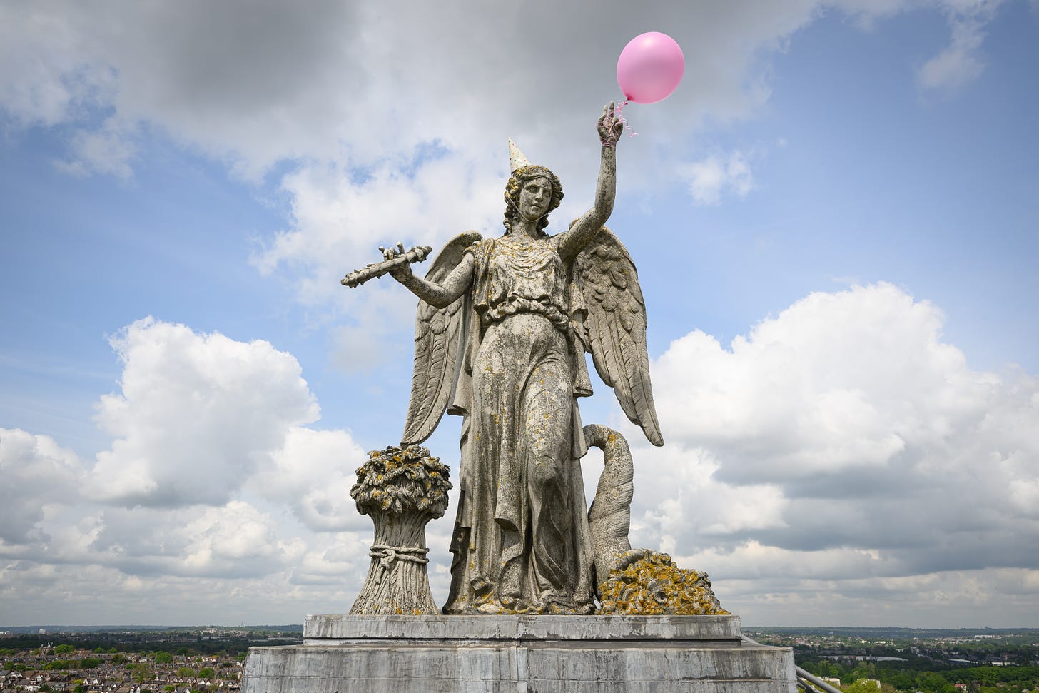 A birthday balloon and party hat is seen on the "Angel of Plenty" statue on the roof of Alexandra Palace on May 17, 2023 in London, England. (Photo by Leon Neal/Getty Images).