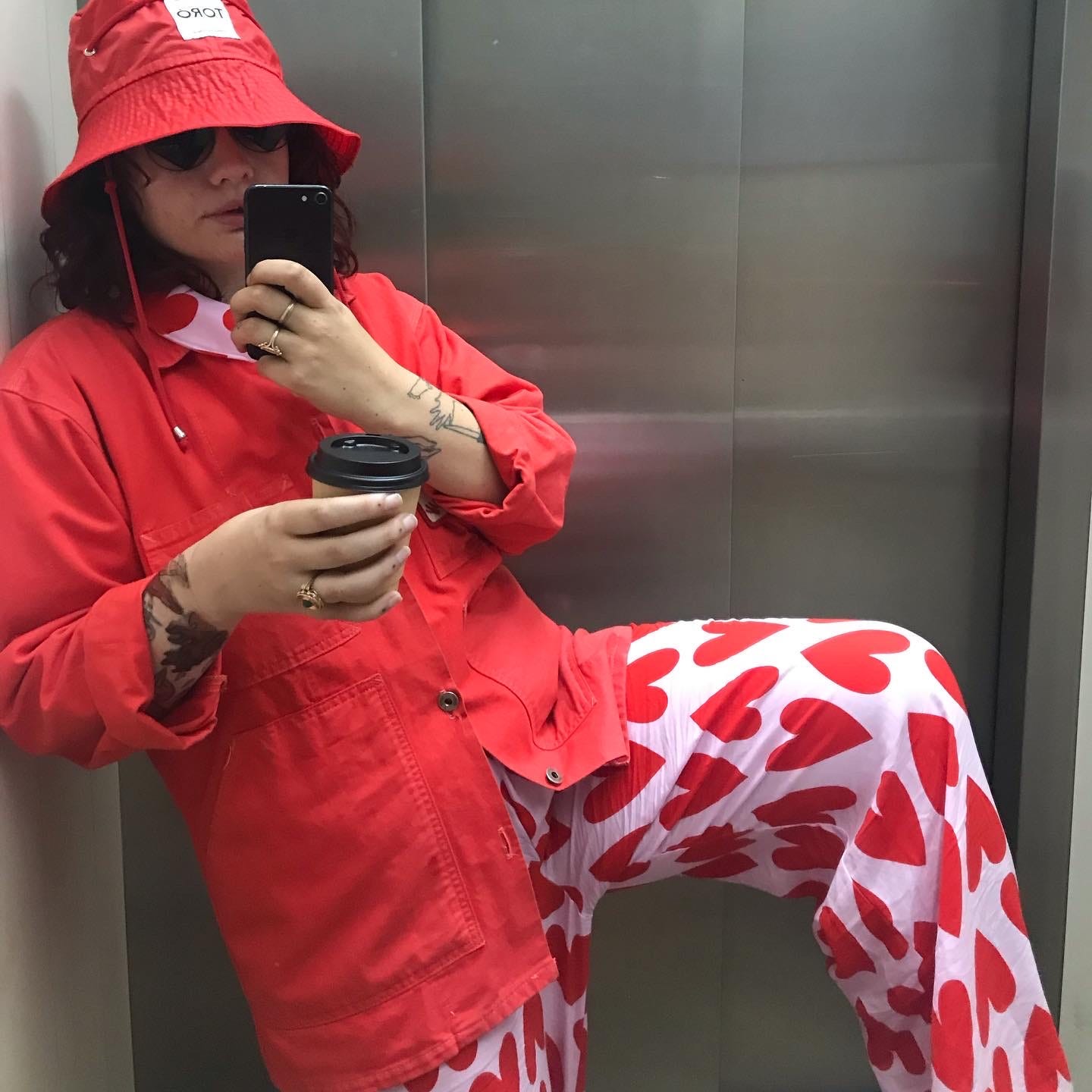 Larissa's pajama 'fit with red work jacket and bucket hat.