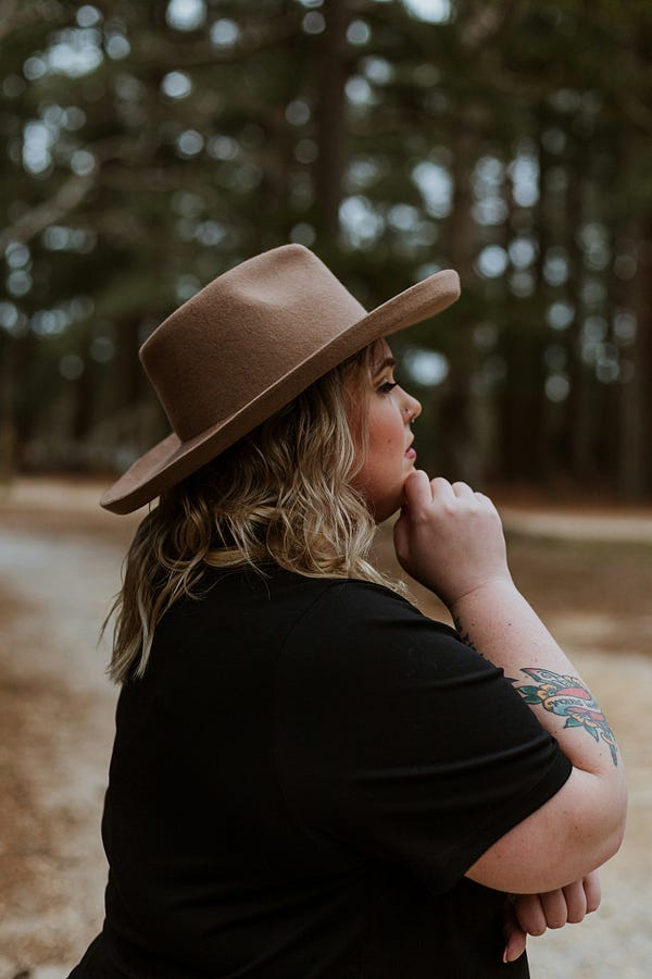 Woman with hat thinking and looking into the distance. Woman with hat thinking and looking into the distance.