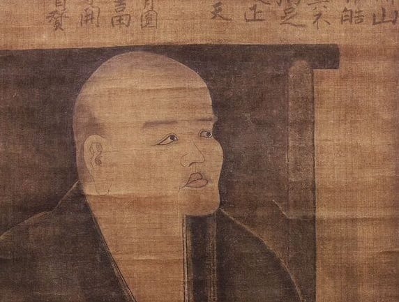A cropped portion of a self-portrait of Eihei Dogen gazing at the moon, painted in 1249. The painting is made on a scroll in sepia tones and you can see some of the scroll’s wrinkles in the image. Dogen has a rounded pale face with high cheekbones and full delineated lips. He is gazing upward and to his left.