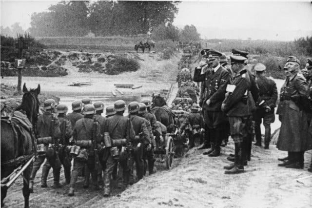 Hitler watching German soldiers marching into Poland in September 1939. (Bundesarchiv)