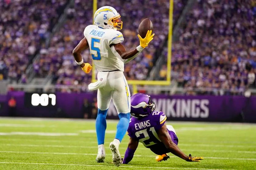 The Chargers' Joshua Palmer (5) makes the deciding a 30-yard touchdown catch against the Vikings.