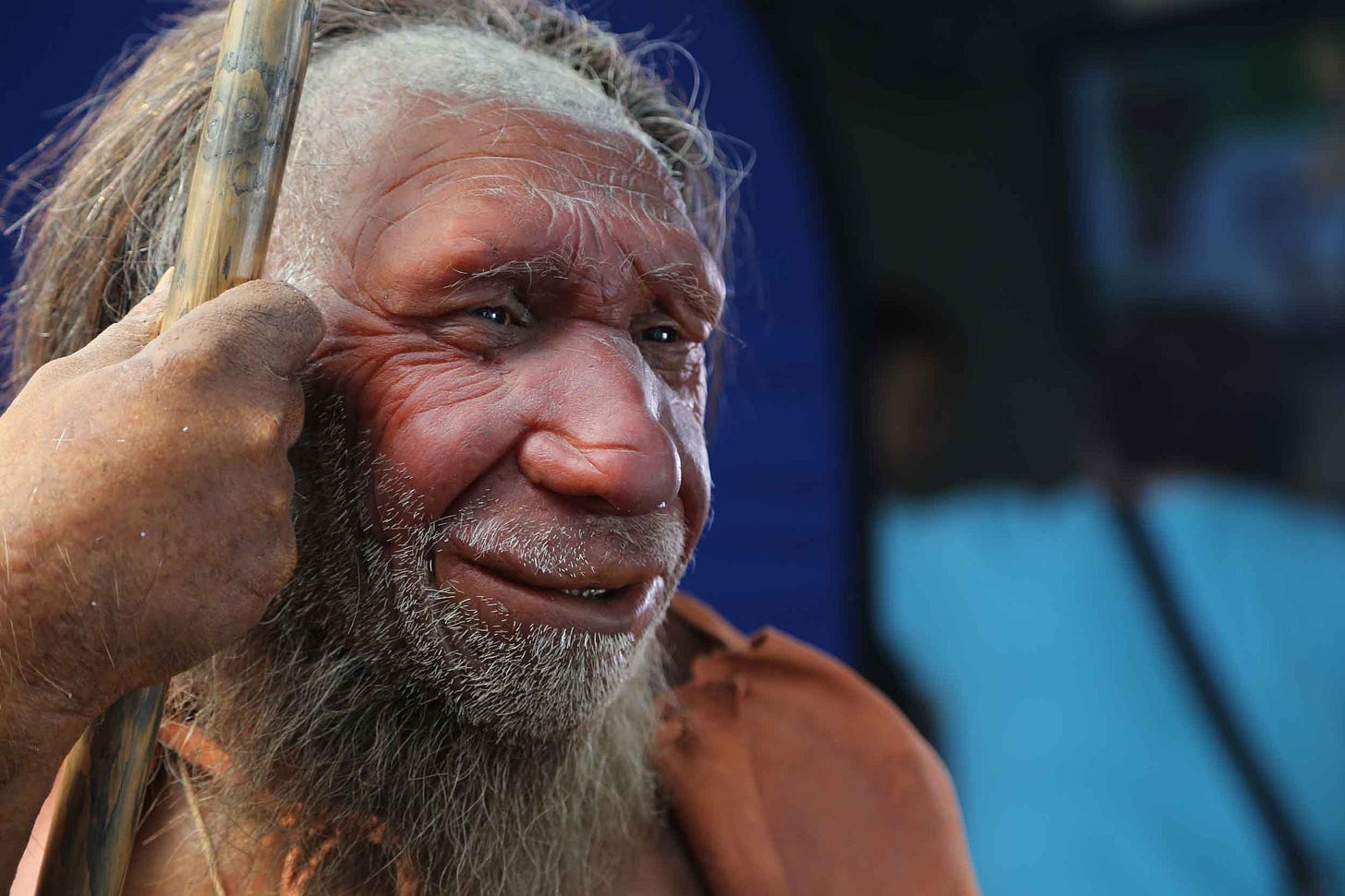 Neandertal face with hand holding a spear