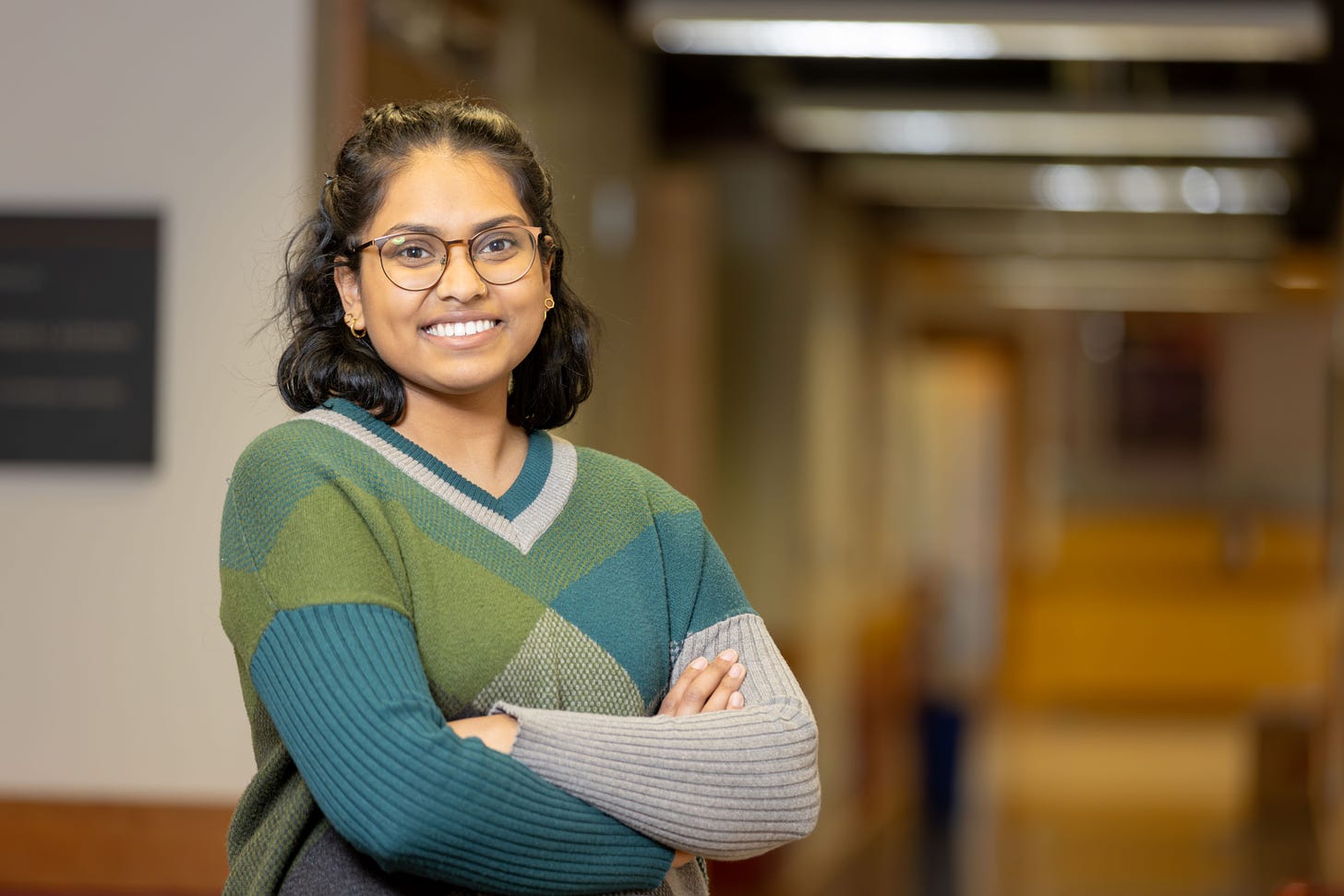 Paige Ramkissoon pictured with arms crossed on JAX campus