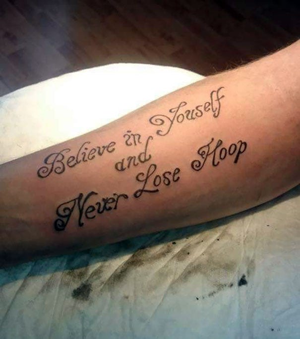 A badly misspelled tattoo that sort of reads "Believe in Yourself and Never Lose Hope."