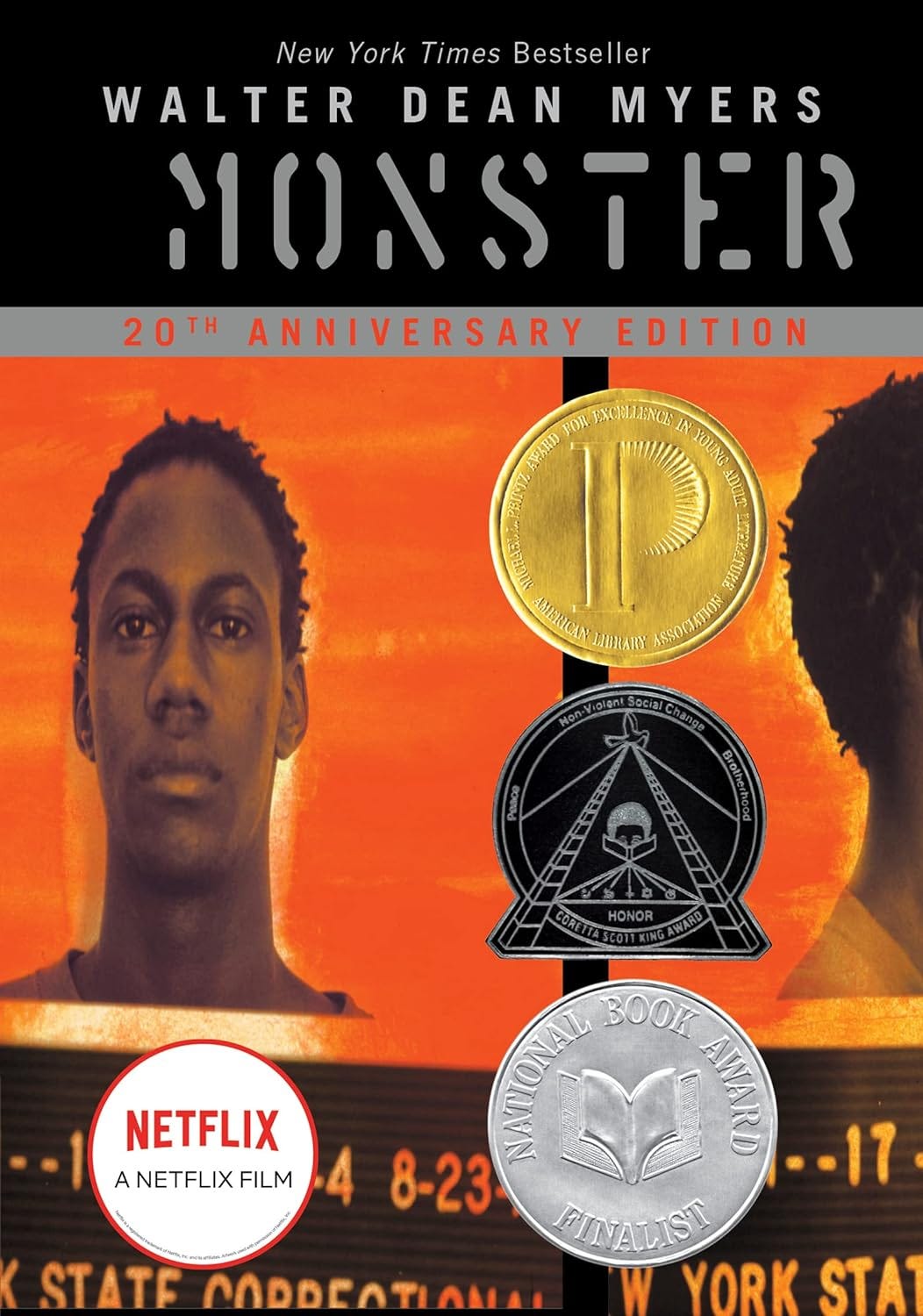 The book cover for “monster” shows an image of a Black teen and several stickers representing the awards teh book won plus a sticker showing it is also a Netflix film.