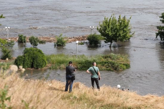 Local residents look at a partially flooded area of Kherson, Ukraine.