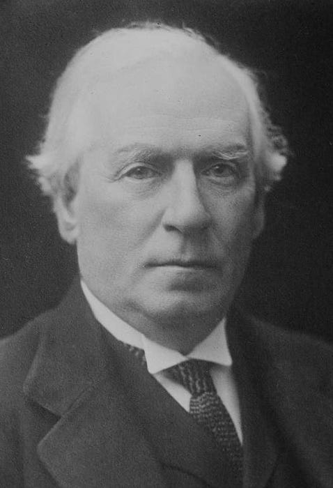 Black and white photo of H.H.Asquith UK Prime Minister. He is looking at the camera and has white hair. He is unsmiling.