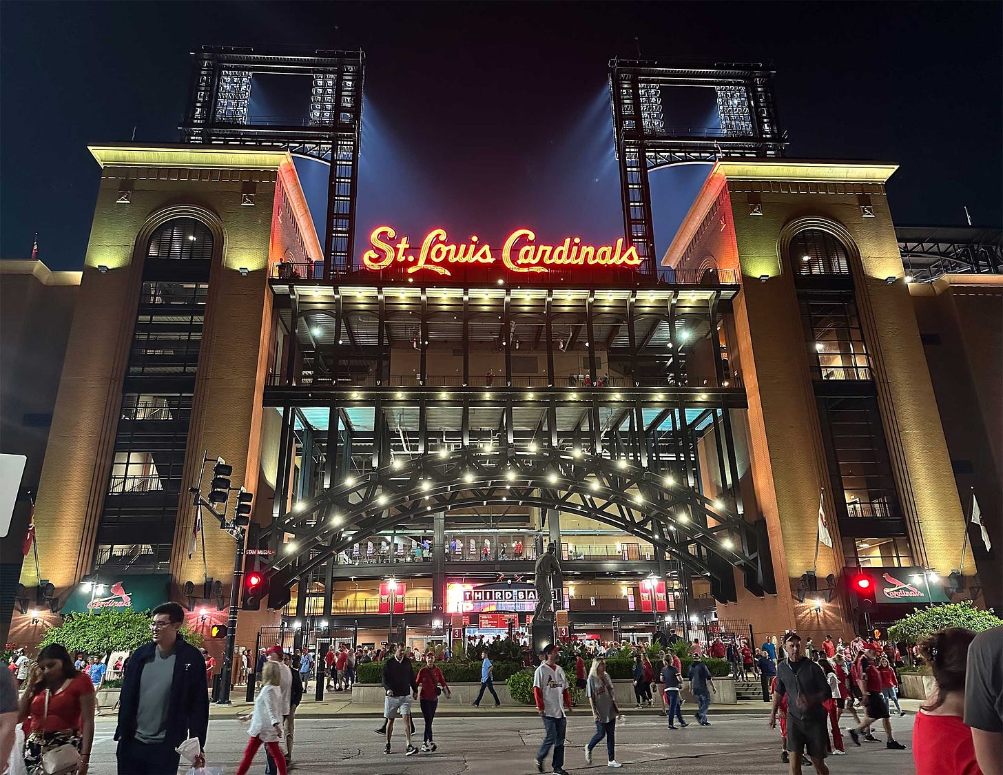Exterior of baseball stadium at night with lit up sign that reads Saint Louis Cardinals.